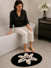 Midnight Lily Oval Bath Mat on a bathroom floor