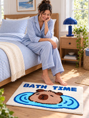Capybara Bath Time Graphic Bath Mat beside a bed