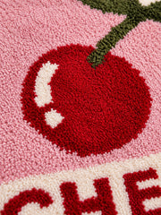 Close-up of the soft microfiber surface of Retro Cherry Graphic Bath Mat - Pink