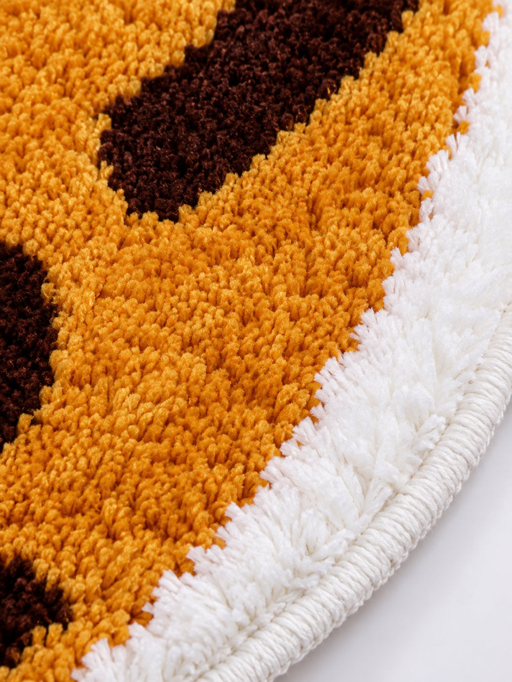 Close-up of the soft microfiber surface of Curled Ginger Cat Shaped Bath Mat