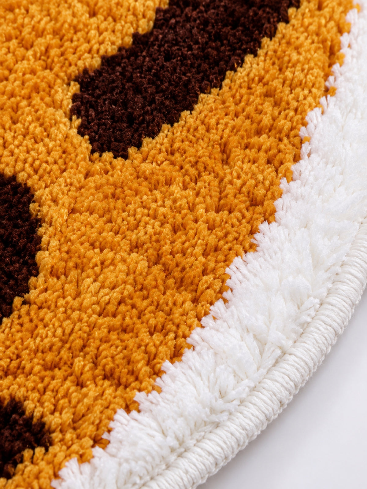 Close-up of the soft microfiber surface of Curled Ginger Cat Shaped Bath Mat