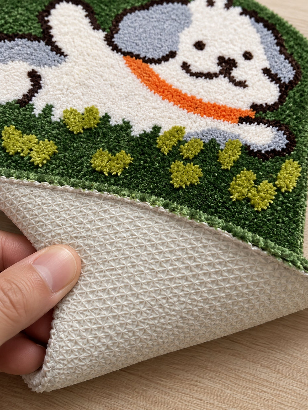 Close-up of the TPE backing of Clover Meadow Pup Shaped Bath Mat