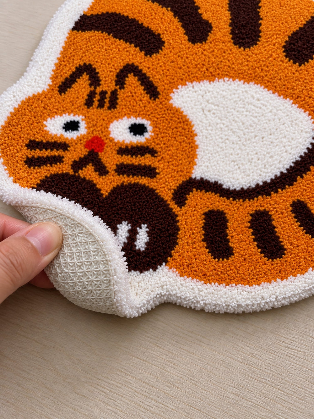 Close-up of the TPE backing of Curled Ginger Cat Shaped Bath Mat