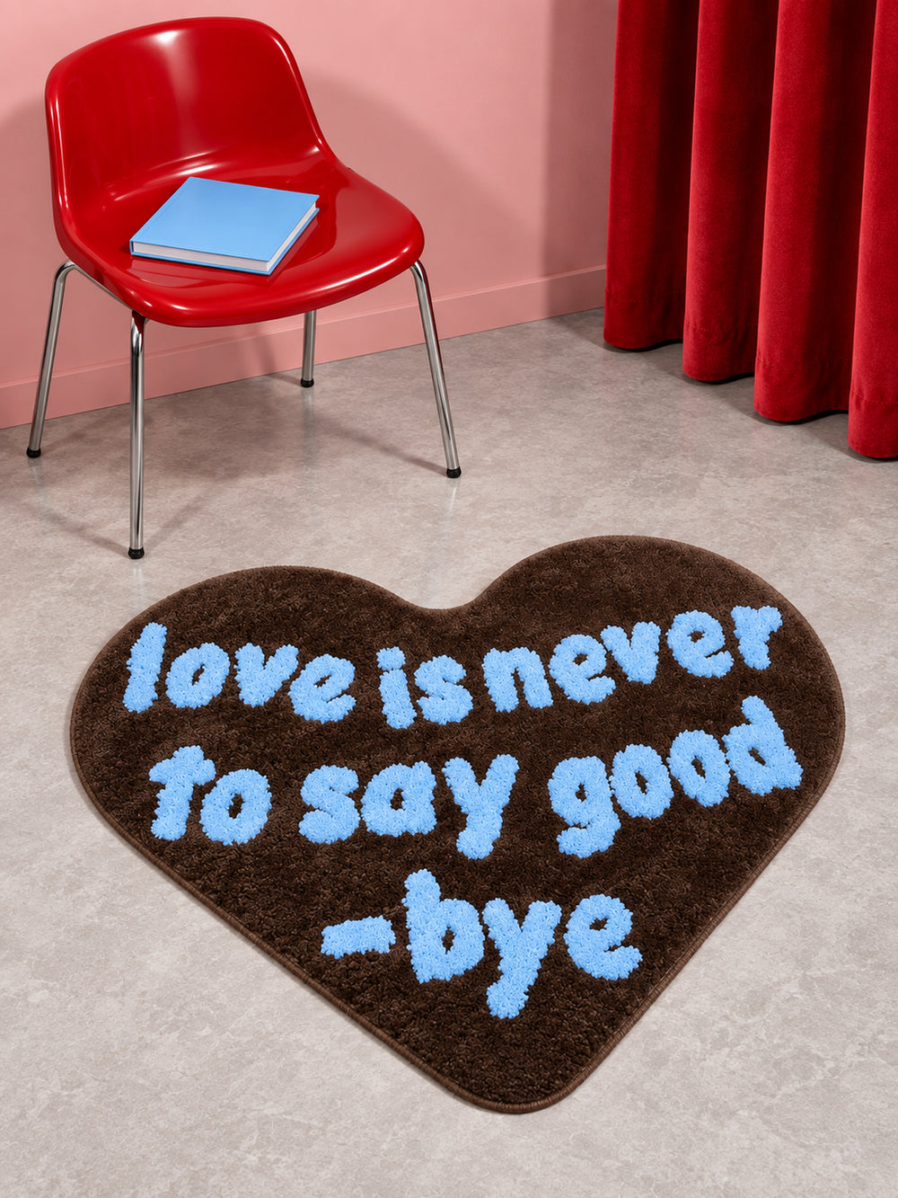 Brown heart-shaped accent rug beside a red chair and blue book