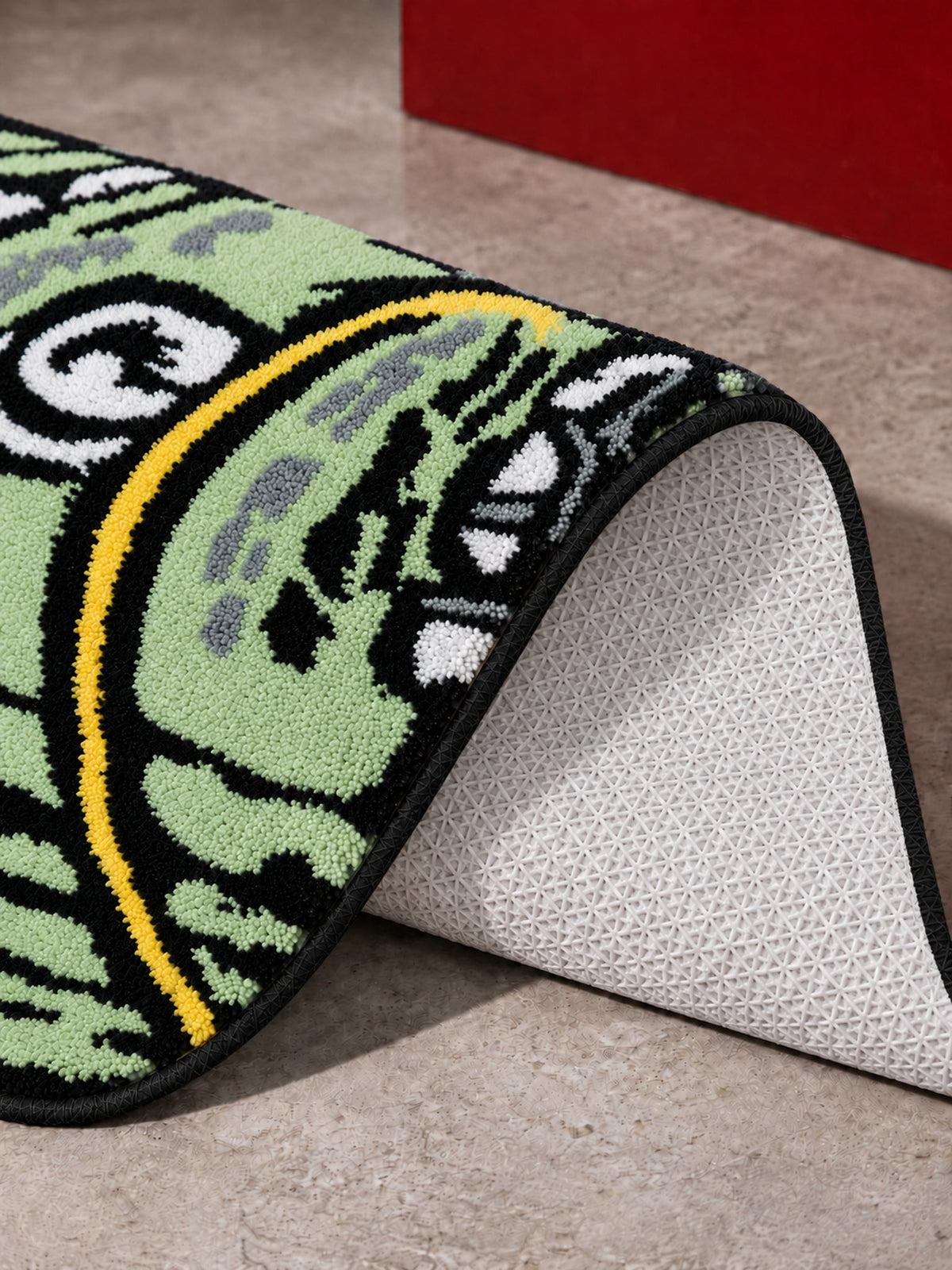 Rolled Cash Bath Mat with one corner lifted to show its textured backing