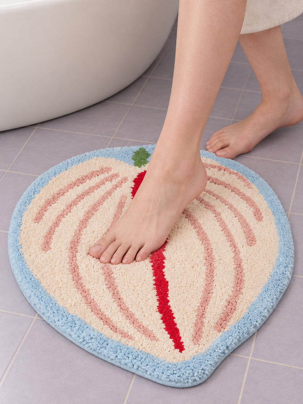 Blush Veined Leaf Bath Mat on a bathroom floor, shown from another angle