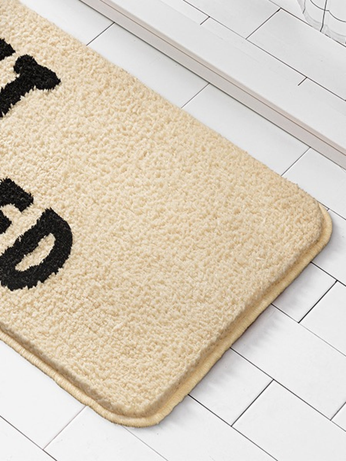 Get Naked Graphic Bath Mat on a bathroom floor, shown from another angle