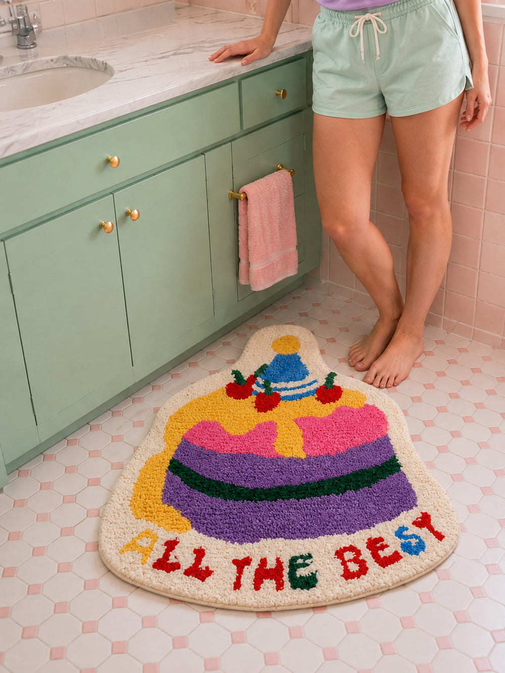 Best Wishes Cake Shaped Bath Mat on a bathroom floor, shown from another angle