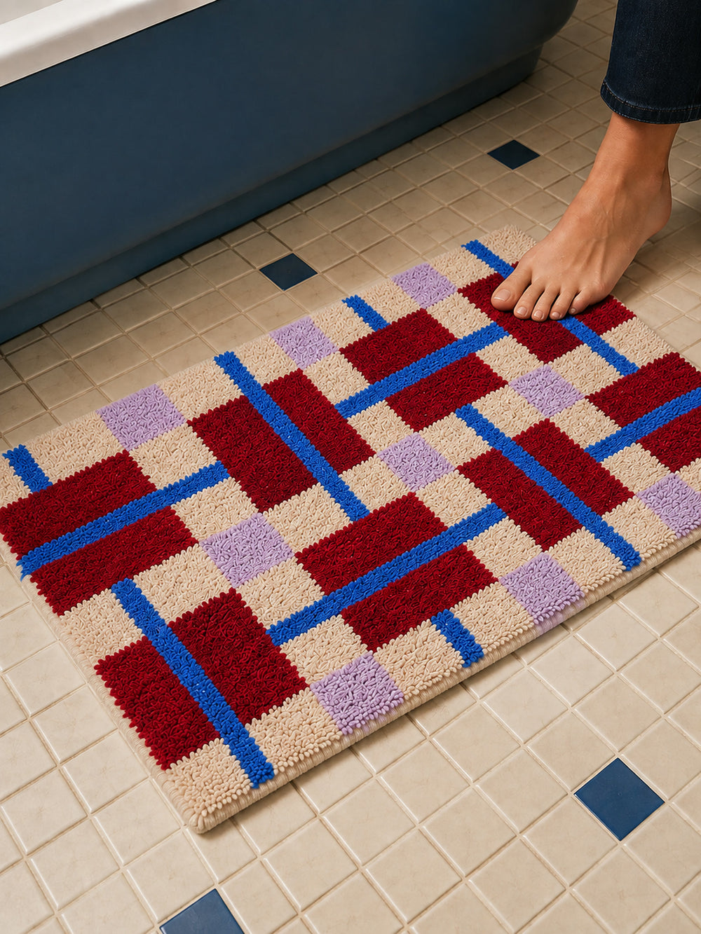 Crimson Grid Colorblock Bath Mat on a bathroom floor, shown from another angle