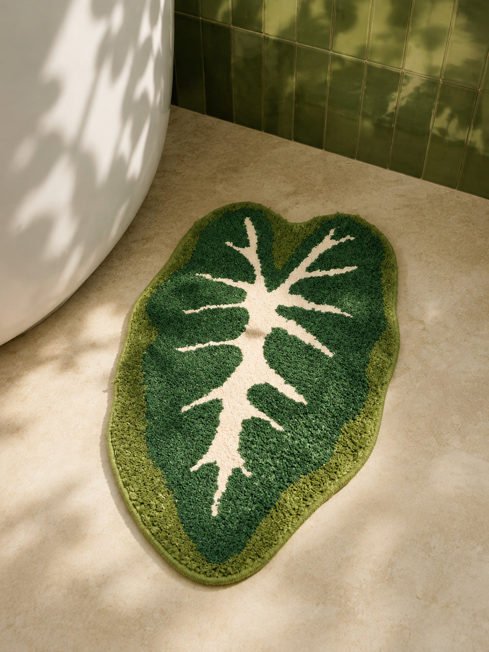 Alocasia Leaf Tropical Green Bath Mat on a bathroom floor, shown from another angle