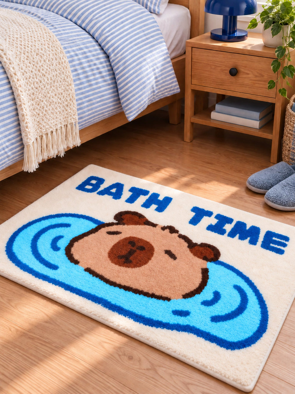 Capybara Bath Time Graphic Bath Mat beside a bed, shown from another angle