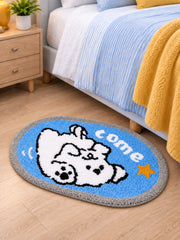 Come Along Puppy Oval Bath Mat beside a bed, shown from another angle