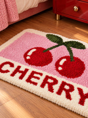 Retro Cherry Graphic Bath Mat - Pink beside a bed, shown from another angle