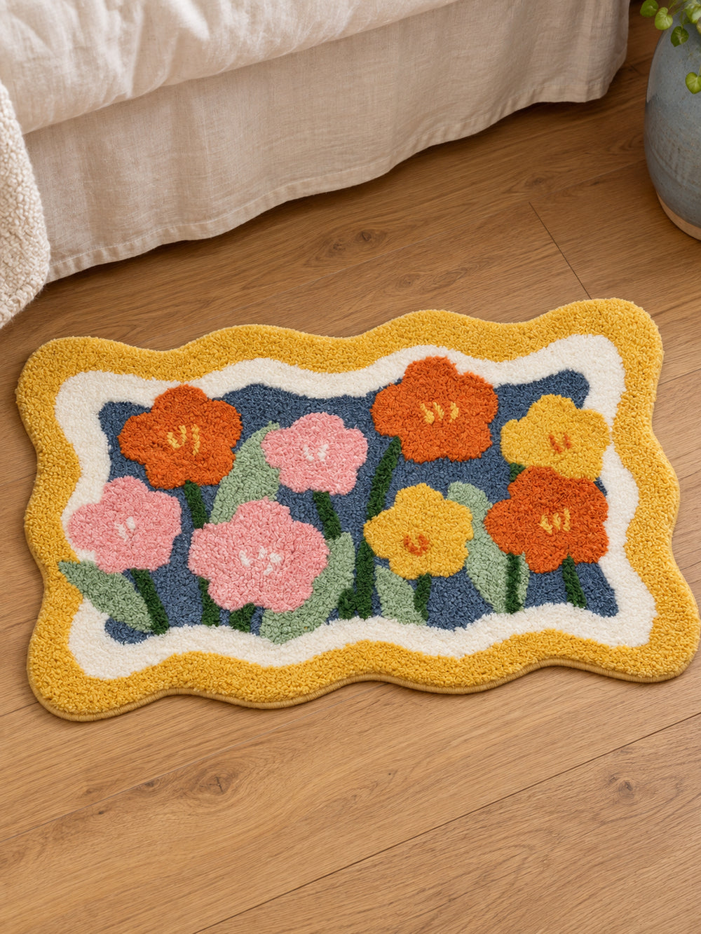 Garden Bloom Wavy Border Bath Mat — bedside context detail