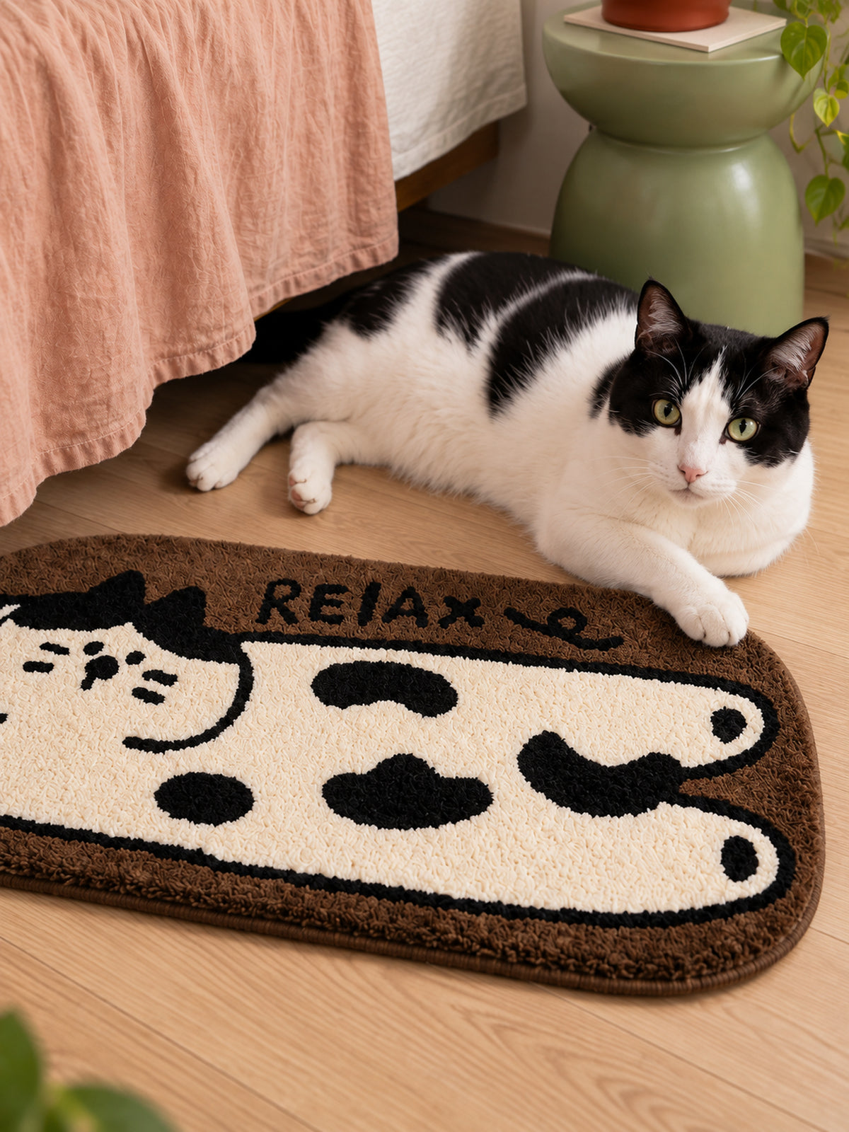 Relaxed Spotted Cat Bath Mat — bedside context detail