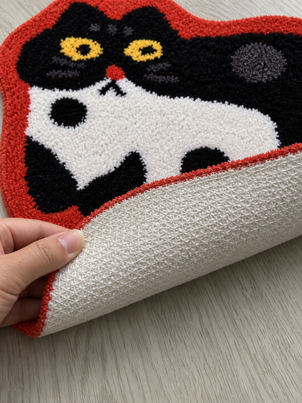 Spotted Cat Red-Outline Bath Mat — backing detail