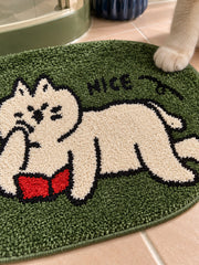 Green reading-cat oval mat, 50 x 80 cm, close-up of the cat, red book and NICE lettering.