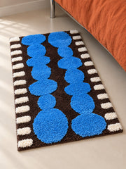 Electric Blue Pebbles Retro Bath Mat — bedside context detail