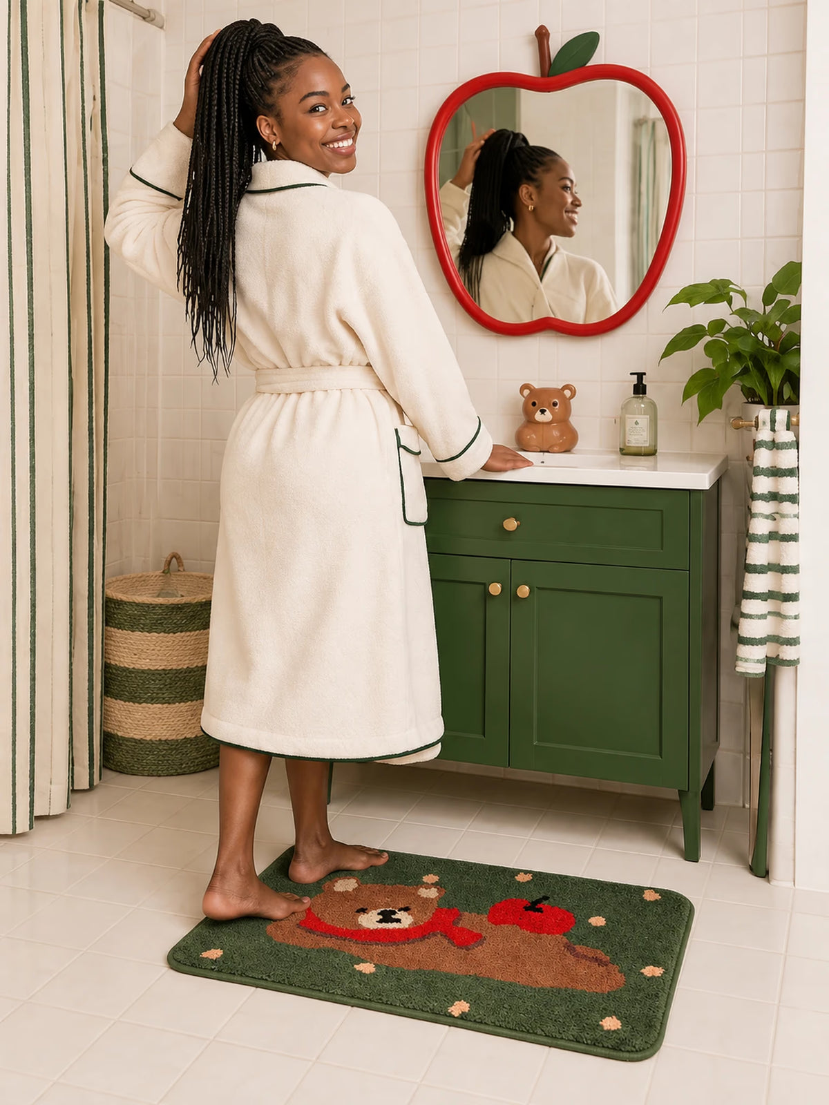 Apple Bear Forest Green Bath Mat on white bathroom tiles by a green vanity