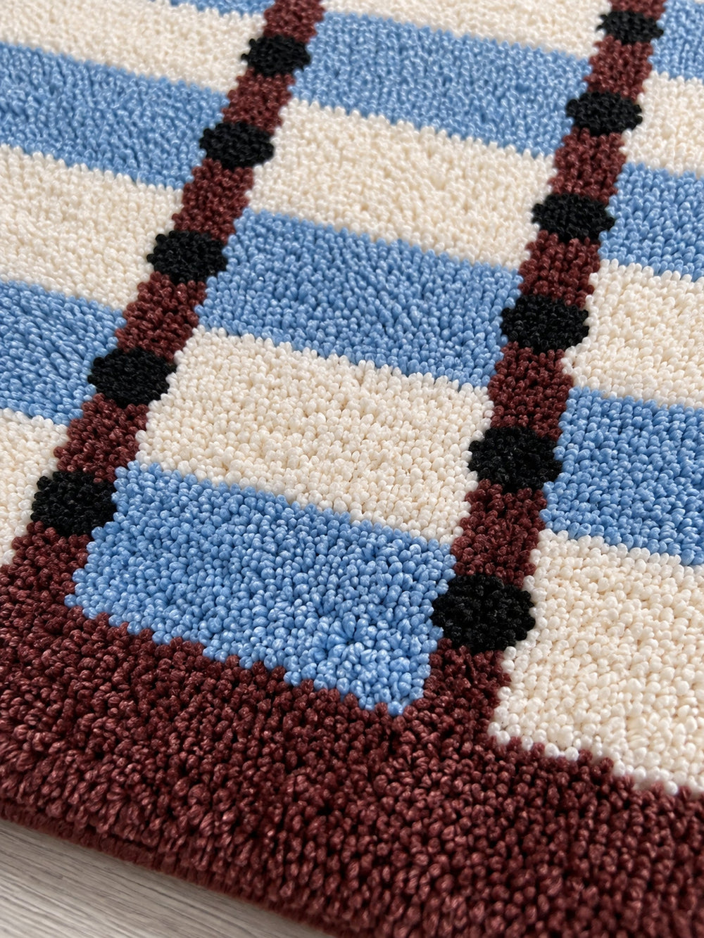 Sage Cocoa Grid Geometric Bath Mat — surface detail