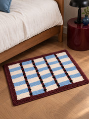 Sage Cocoa Grid Geometric Bath Mat — bedside context detail