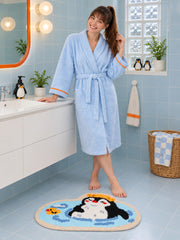 Penguin Bubble Bath Mat on a pale blue bathroom floor