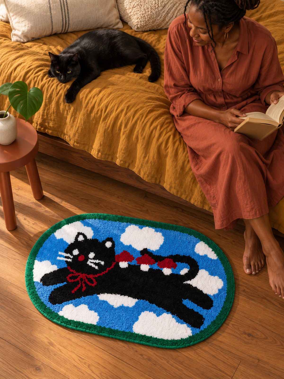 Red Ribbon Cat Cloud Bath Mat — bedside context detail