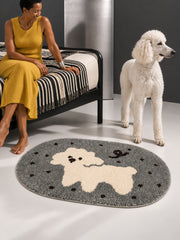 Gray polka-dot pup oval mat, 50 x 80 cm, beside a seated person, a white poodle and a striped bed.