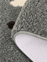 Gray polka-dot pup oval mat, 50 x 80 cm, with its edge folded to reveal the pale patterned backing.