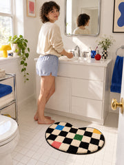 Color Pop Wavy Checkerboard Bath Mat on a bathroom floor