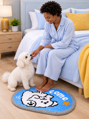 Come Along Puppy Oval Bath Mat beside a bed