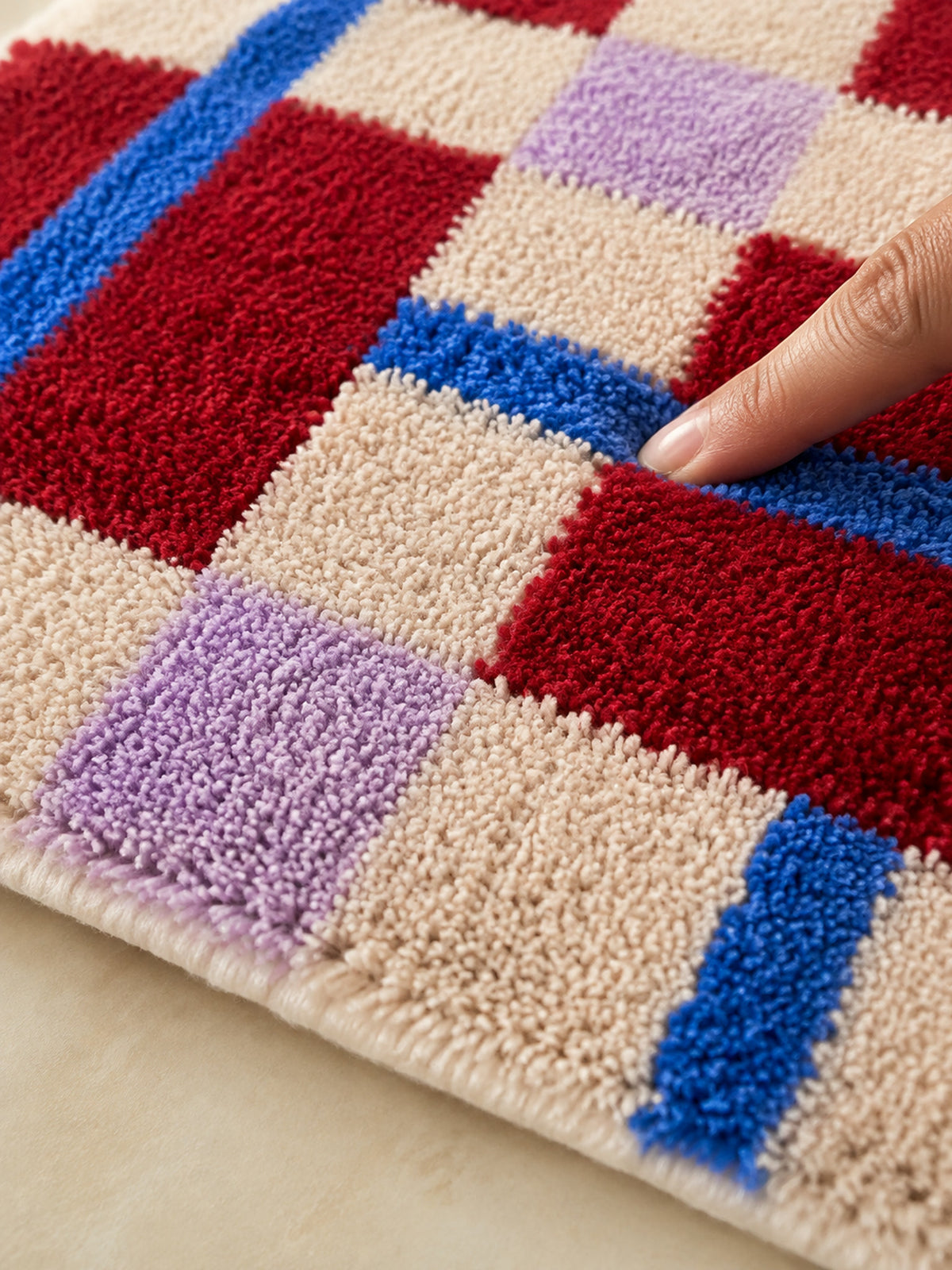 Close-up of the soft microfiber surface of Crimson Grid Colorblock Bath Mat