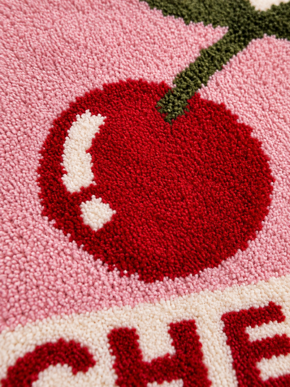Close-up of the soft microfiber surface of Retro Cherry Graphic Bath Mat - Pink