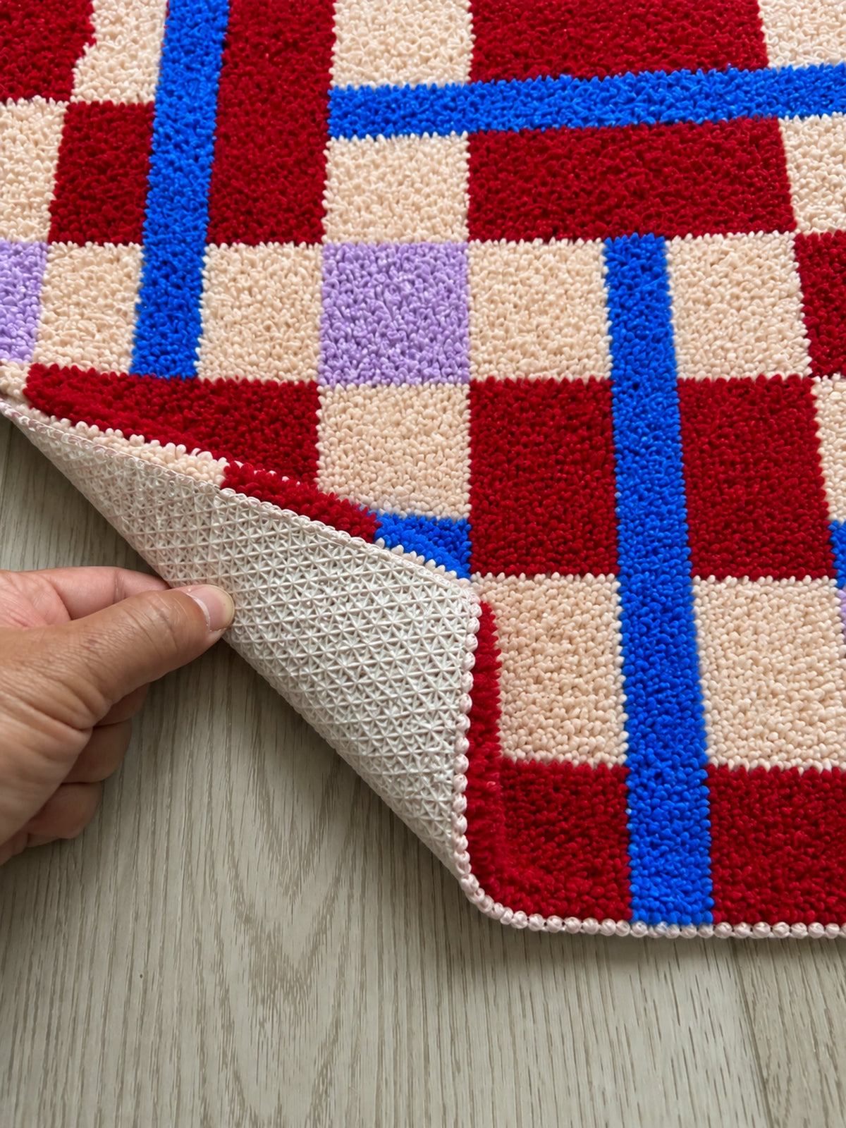 Close-up of the TPE backing of Crimson Grid Colorblock Bath Mat