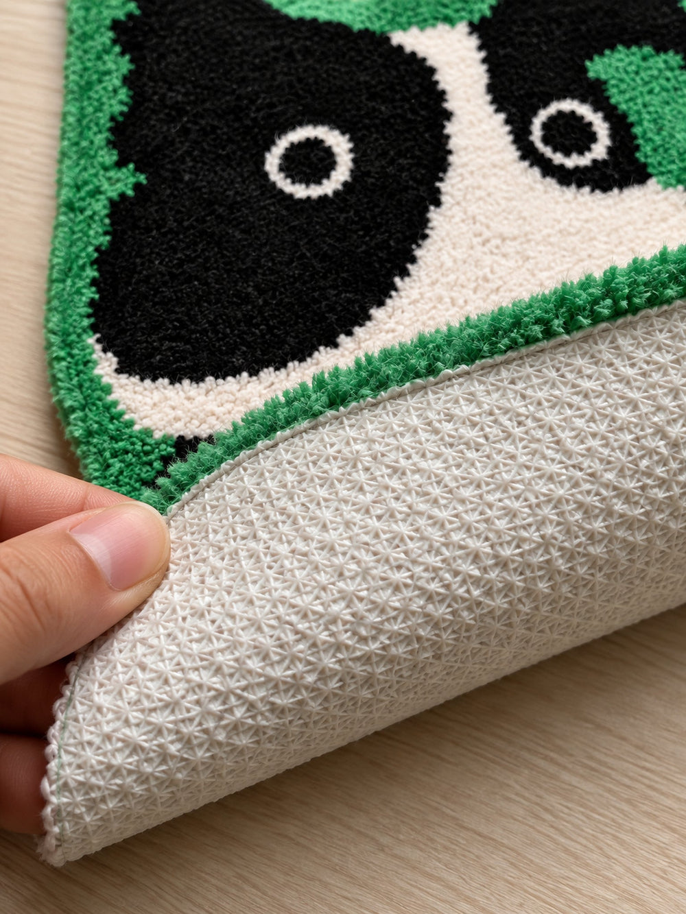 Close-up of the TPE backing of Black & White Puppy Shaped Bath Mat