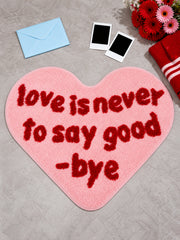 Pink heart-shaped accent rug with a blue envelope and flowers