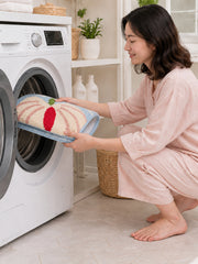 Blush Veined Leaf Bath Mat being machine washed