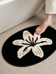 Midnight Lily Oval Bath Mat on a bathroom floor, shown from another angle