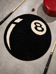 Black eight-ball round rug, 80 cm diameter, viewed from above between pool cues.
