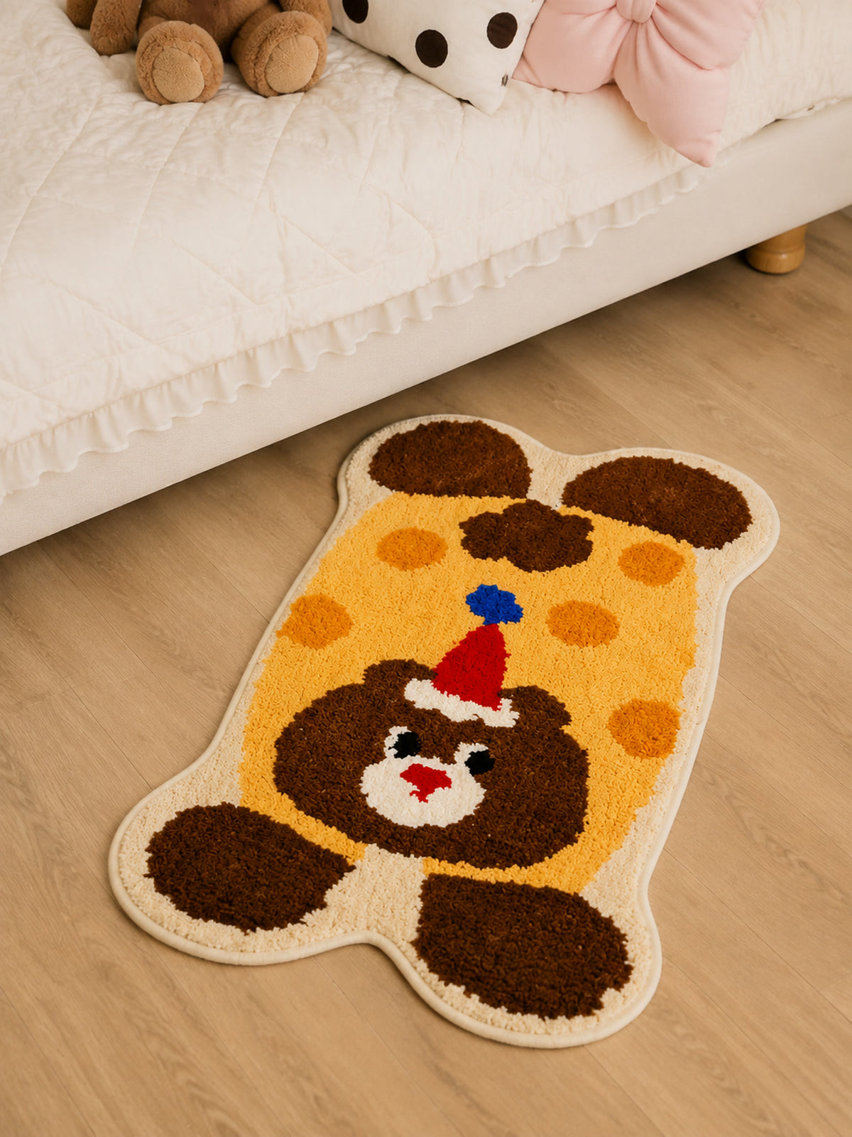 Party Bear Polka-Dot Bath Mat beside a bed, shown from another angle
