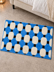 Coastal Blue Basketweave Pattern Bath Mat beside a bed, shown from another angle
