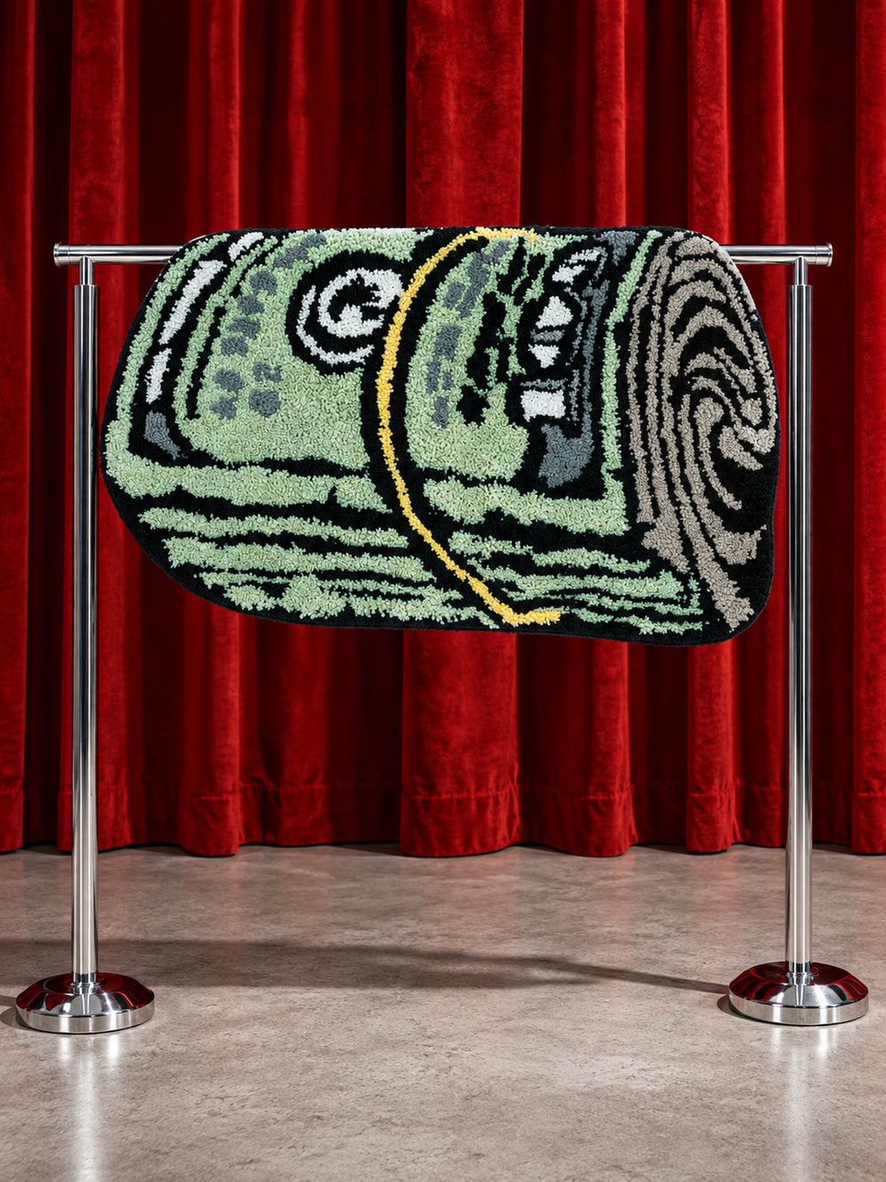 Rolled Cash Bath Mat displayed over a rail against red curtains