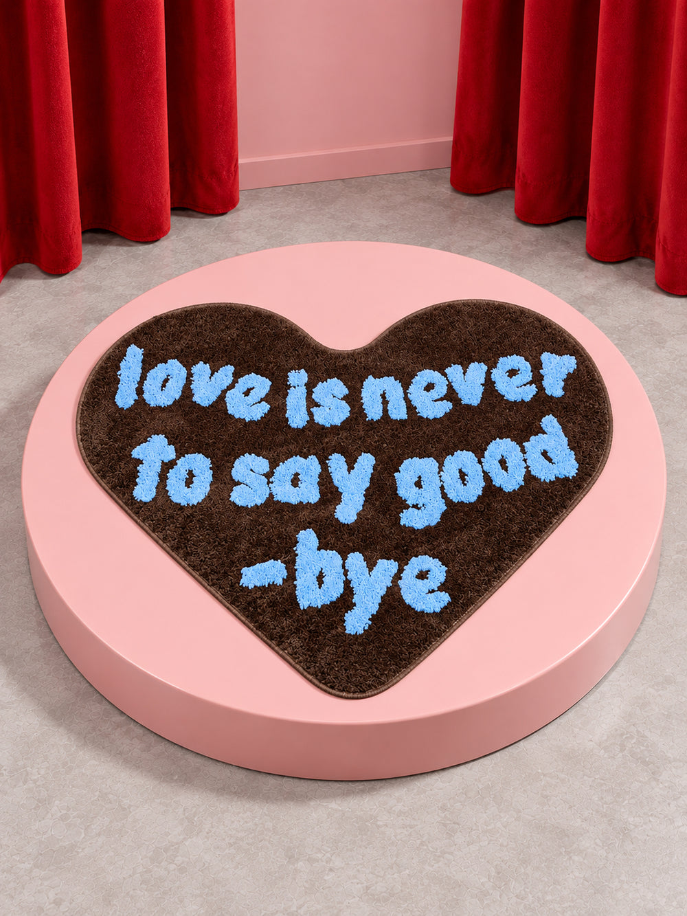 Brown heart-shaped accent rug displayed on a pink round platform