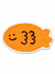 Smiling Orange Fish Shaped Bath Mat on a white background