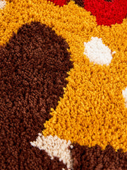 Hot dog dachshund-shaped mat, 50 x 80 cm, close-up of the brown and yellow textured surface.