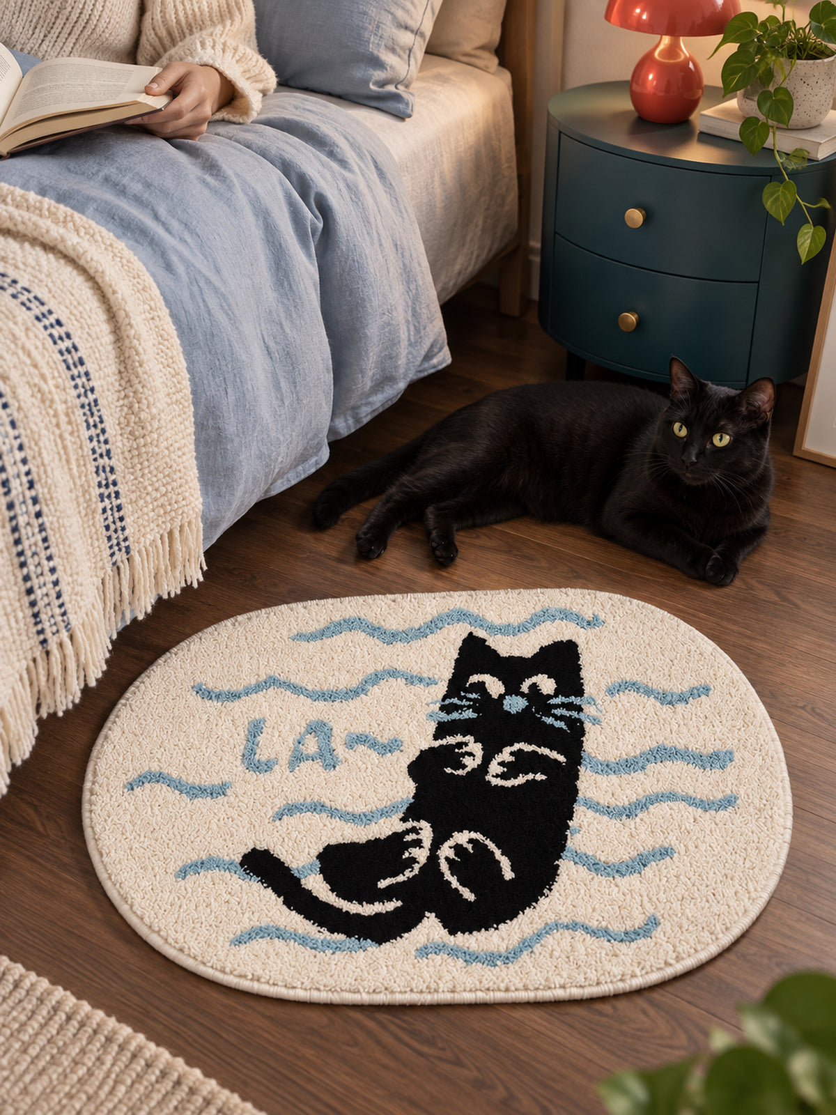 Poolside Black Cat Oval Bath Mat — bedroom scene