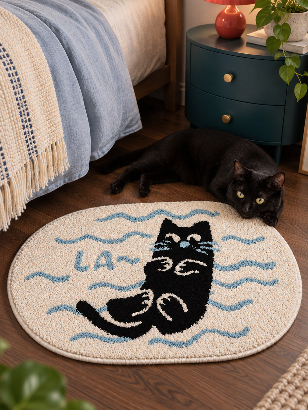 Poolside Black Cat Oval Bath Mat — bedside context detail