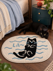 Poolside Black Cat Oval Bath Mat — bedside context detail
