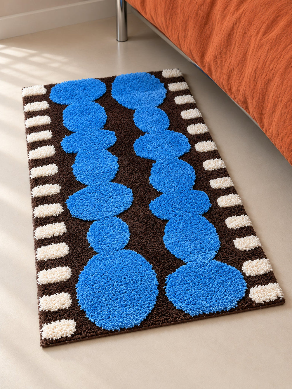 Electric Blue Pebbles Retro Bath Mat — bedside context detail