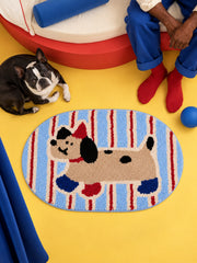 Blue and red striped playful pup mat, 50 x 80 cm, viewed from above beside a dog and curved red seat.